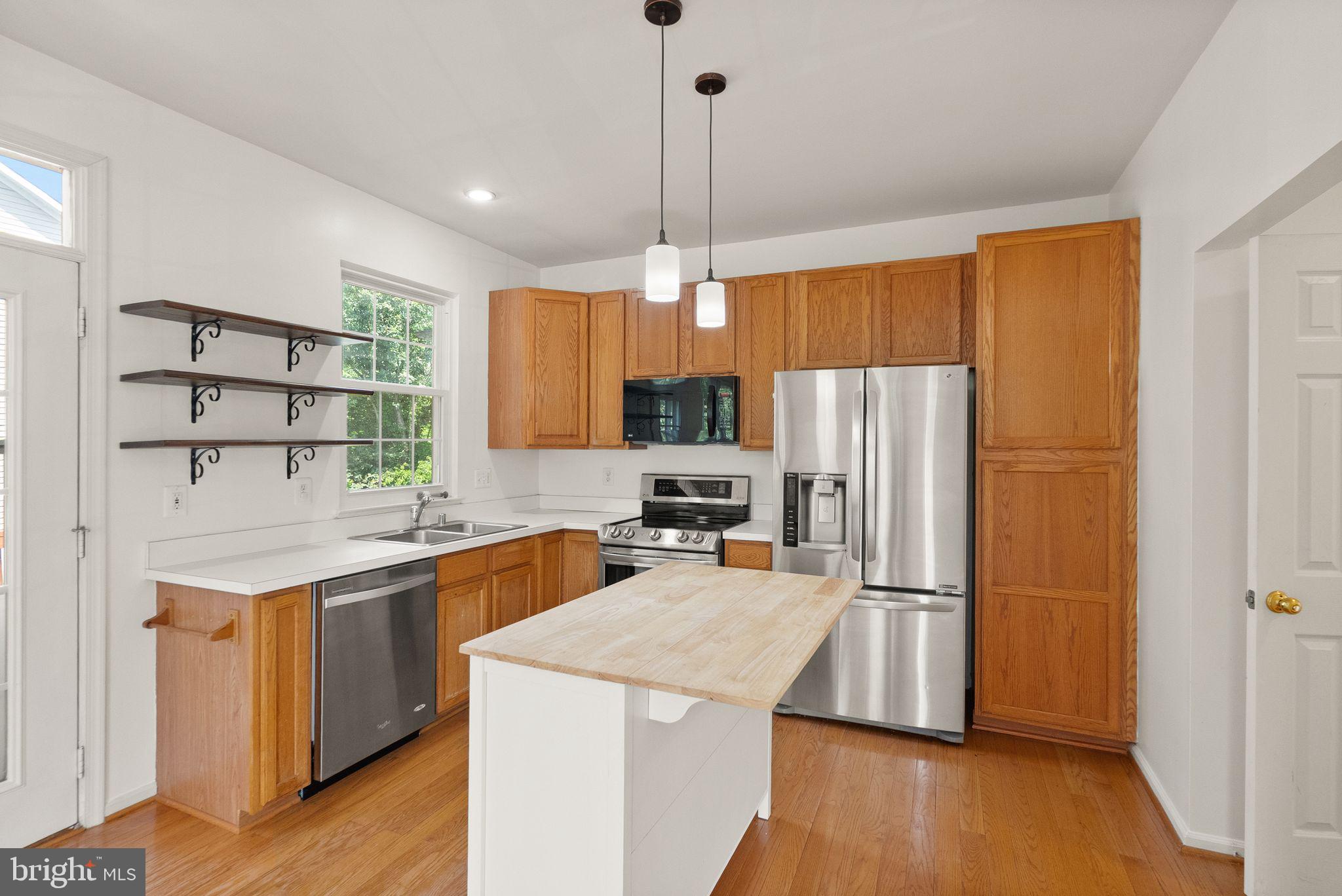 21659 Frame Square Broadlands, VA 20148 - Photo 23 of 68 a kitchen with a refrigerator a stove a sink dishwasher and wooden floor