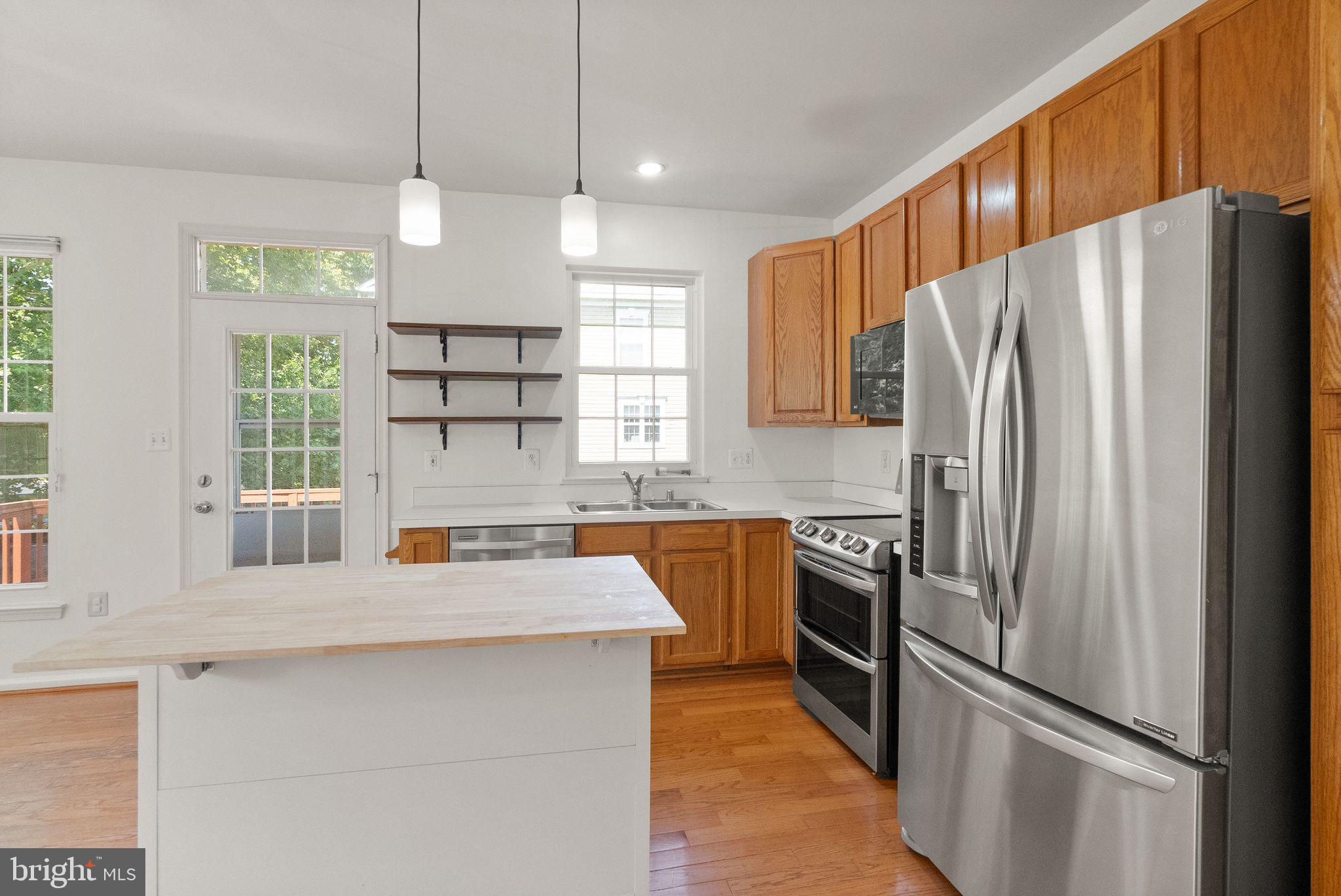 21659 Frame Square Broadlands, VA 20148 - Photo 27 of 68 a kitchen with stainless steel appliances granite countertop a refrigerator a sink a stove and a center island