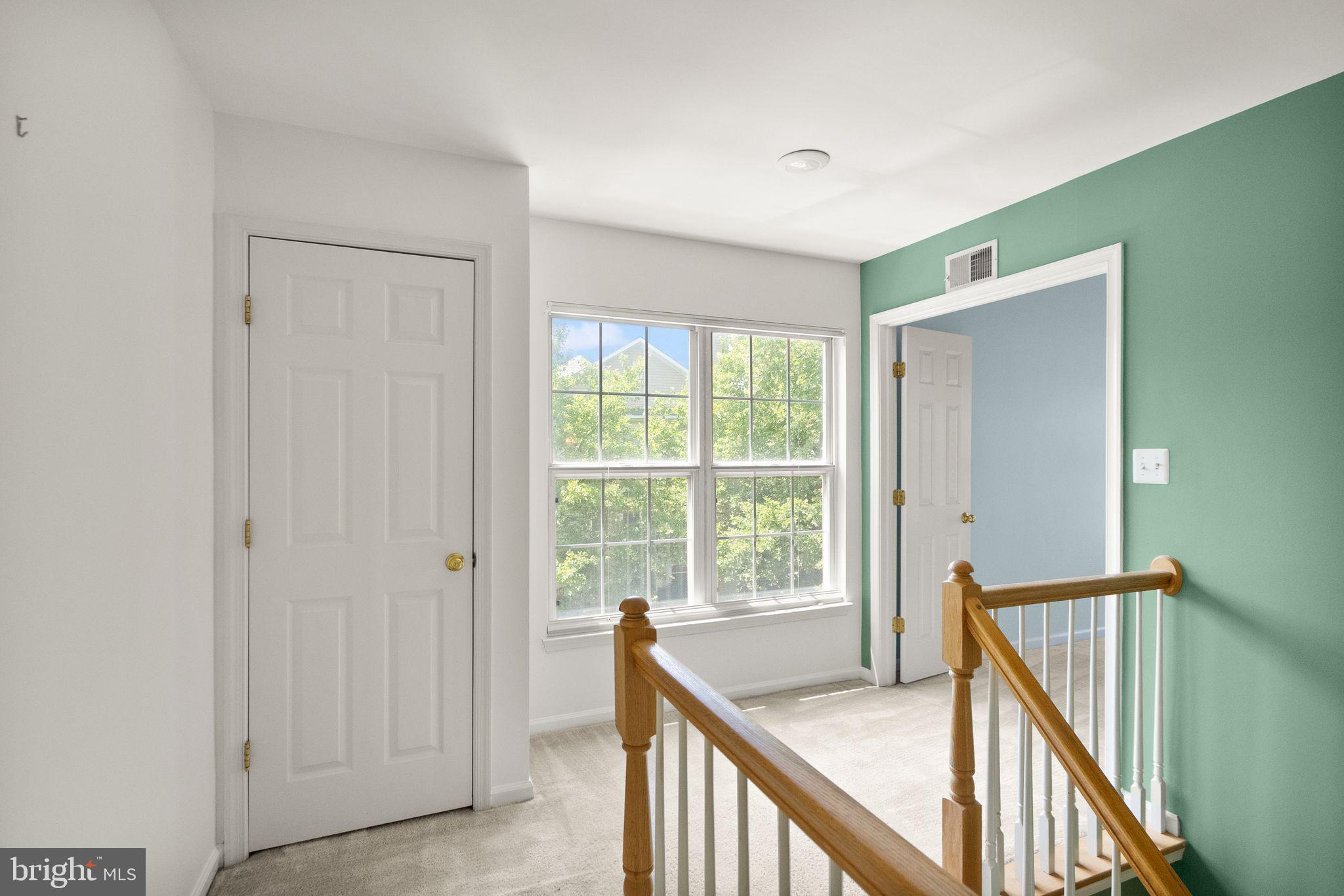 21659 Frame Square Broadlands, VA 20148 - Photo 37 of 68 a view of a hallway with wooden floor and stairs