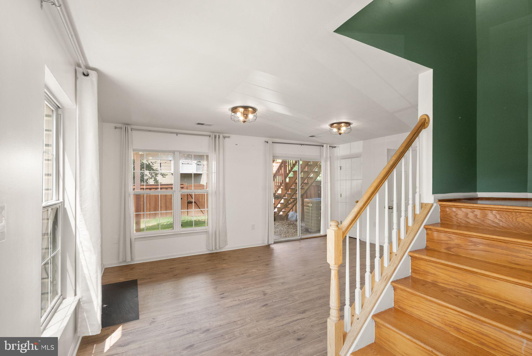 21659 Frame Square Broadlands, VA 20148 - Photo 6 of 68 a view of an entryway with wooden floor and stairs