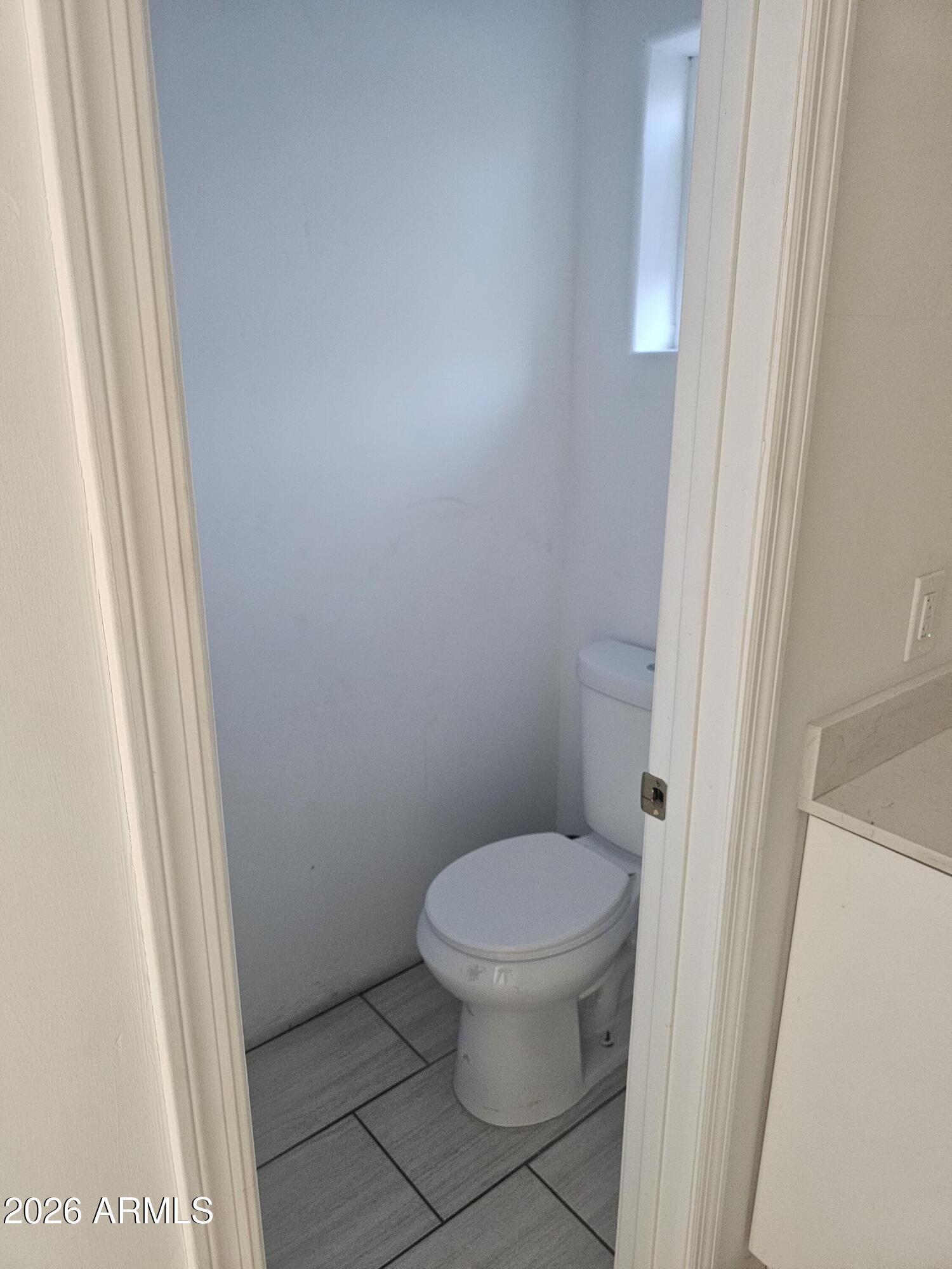 3021 West Almeria Road Phoenix, AZ 85009 - Photo 14 of 17 a white toilet sitting next to a sink
