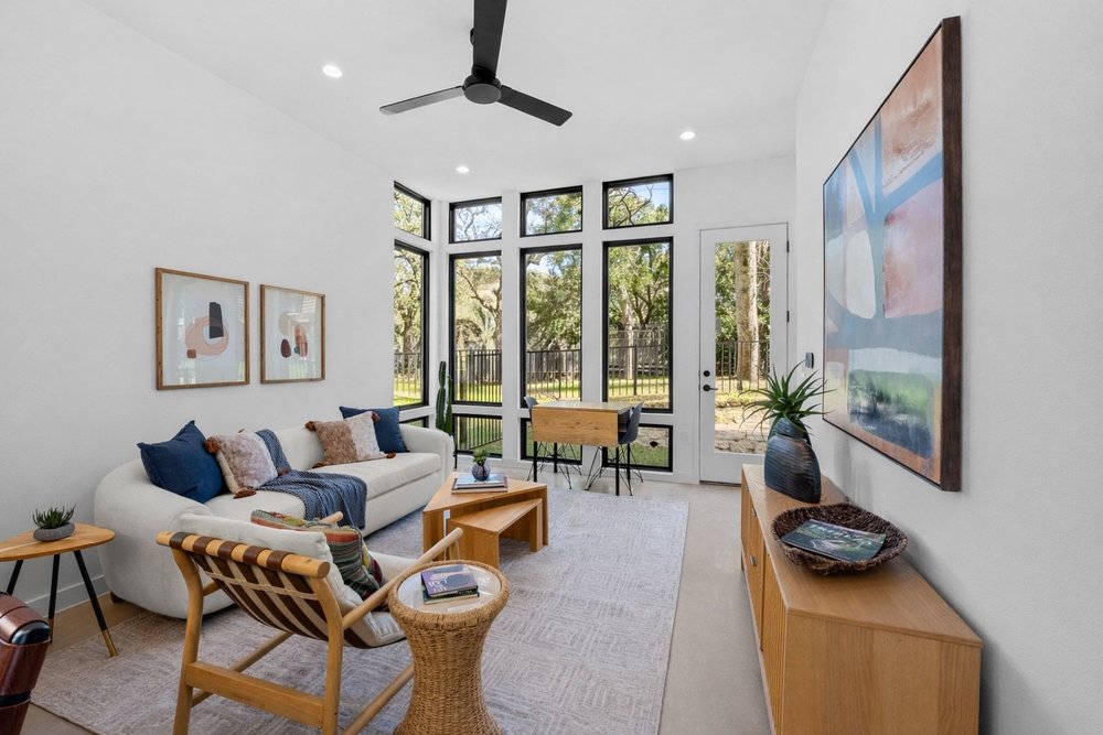 a living room with furniture and a large window
