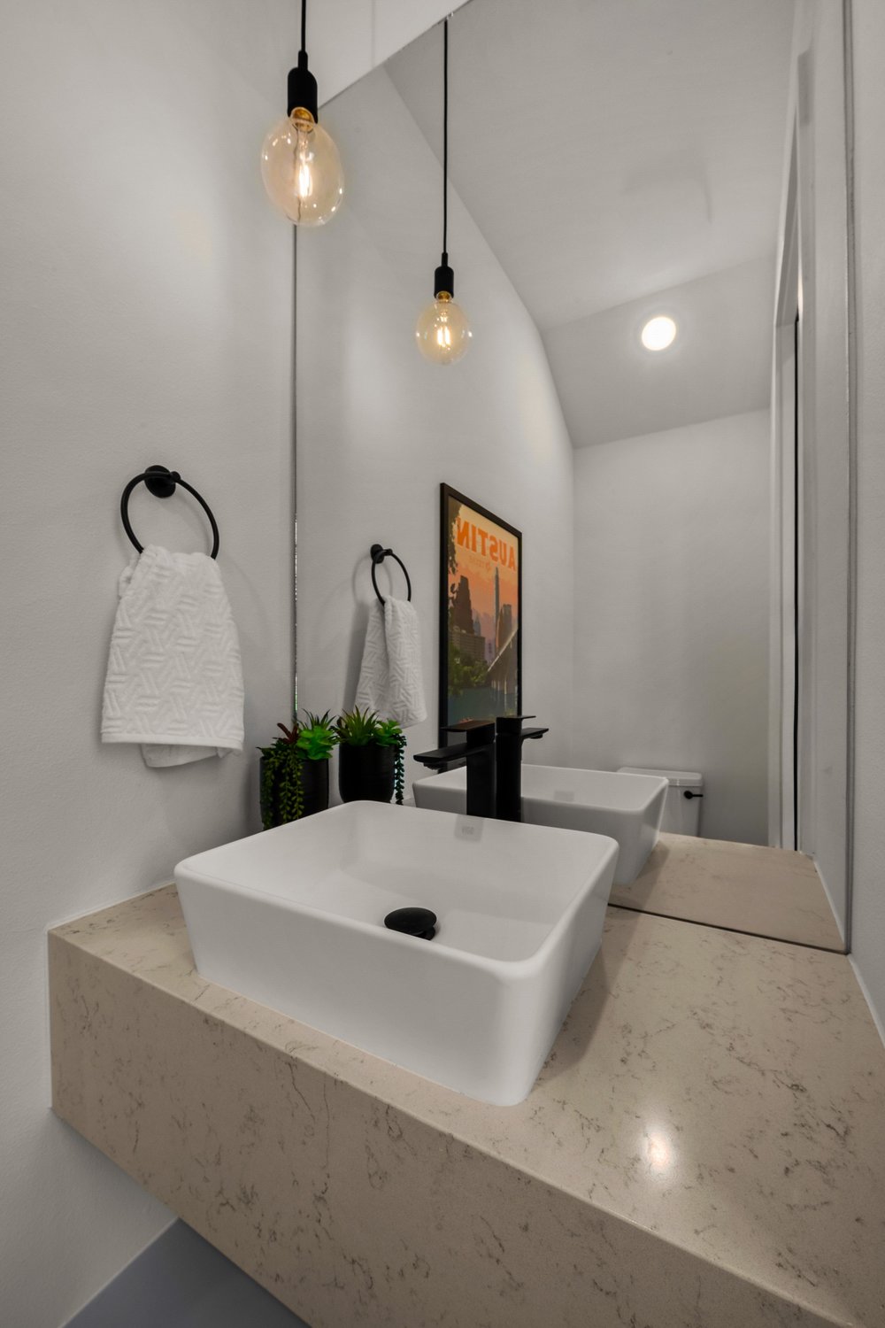 219 Lessin Lane, Unit 10A Austin, TX 78704 - Photo 11 of 28 a bathroom with a sink a light fixture and a mirror
