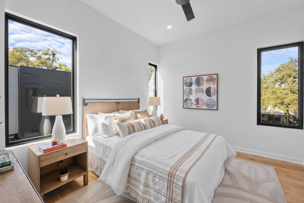 219 Lessin Lane, Unit 10A Austin, TX 78704 - Photo 17 of 28 a bedroom with bed and a night stand