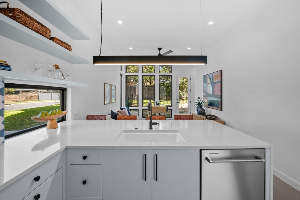 219 Lessin Lane, Unit 10A Austin, TX 78704 - Photo 6 of 28 a kitchen with stainless steel appliances a sink and large windows