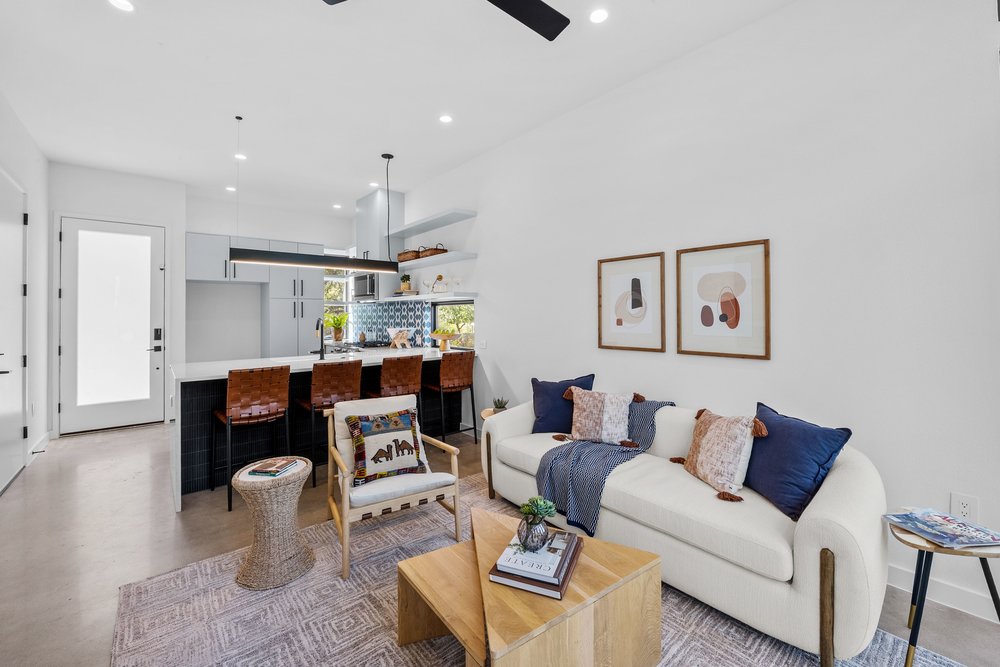 219 Lessin Lane, Unit 10A Austin, TX 78704 - Photo 9 of 28 a living room with furniture and a chandelier