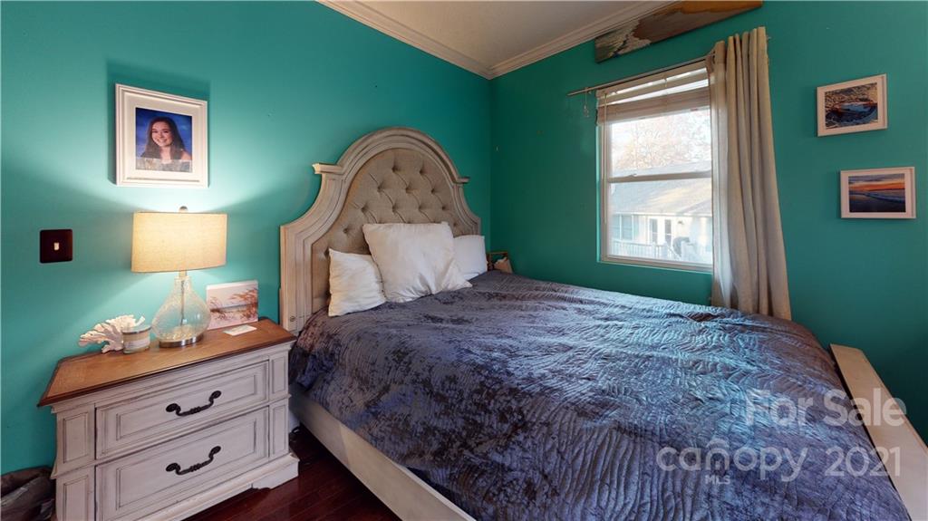 171 Higgins Road, Unit LO 83 Fletcher, NC 28732 - Photo 22 of 42 a bedroom with a bed and a lamp on dresser