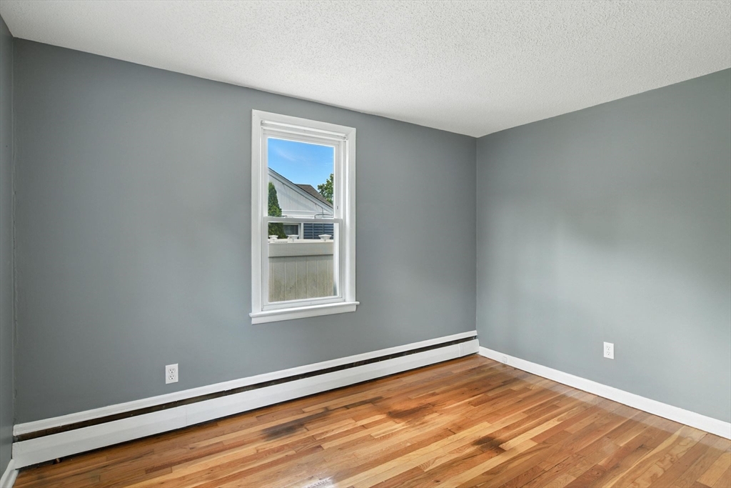 128 Drexel Street Springfield, MA 01104 - Photo 26 of 38 a view of an empty room with wooden floor and a window