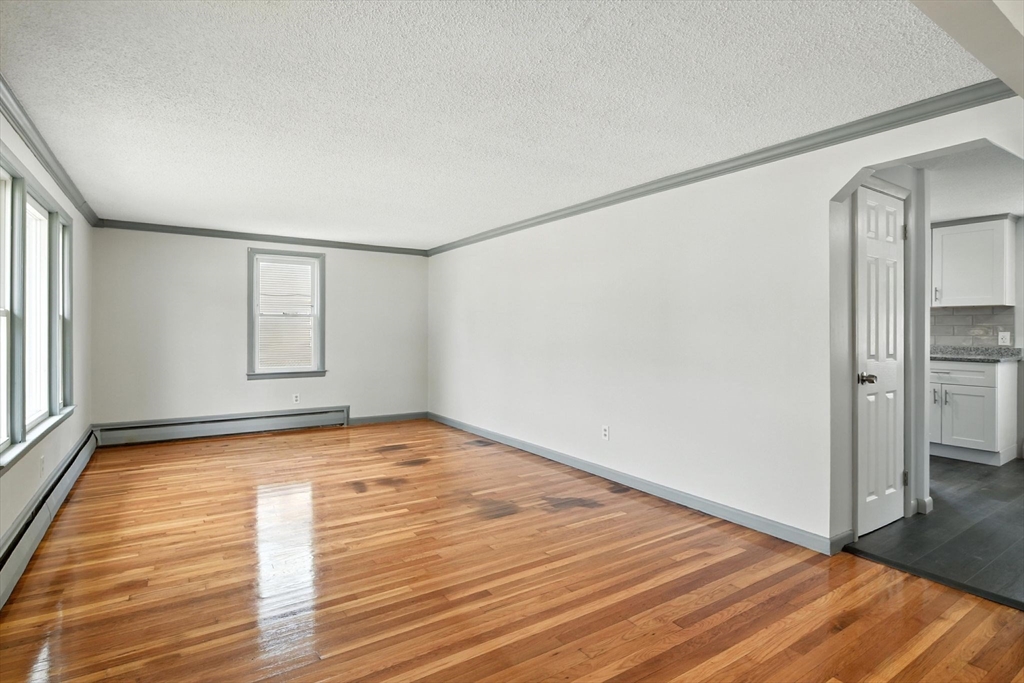 128 Drexel Street Springfield, MA 01104 - Photo 6 of 38 a view of empty room with wooden floor and fan