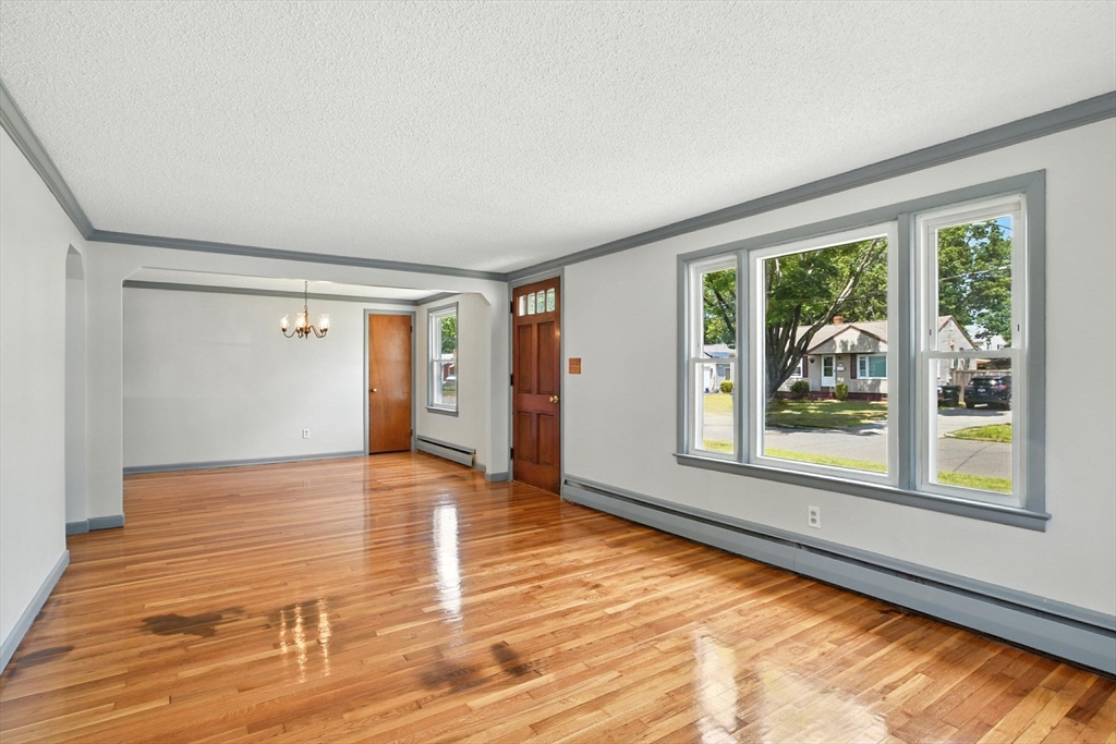 128 Drexel Street Springfield, MA 01104 - Photo 8 of 38 a view of an empty room with a window and wooden floor