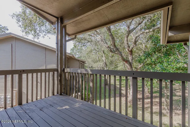 a balcony with wooden floor in outdoor space
