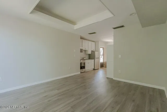 a view of a kitchen with wooden floor
