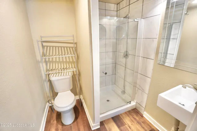 a bathroom with a toilet and a shower