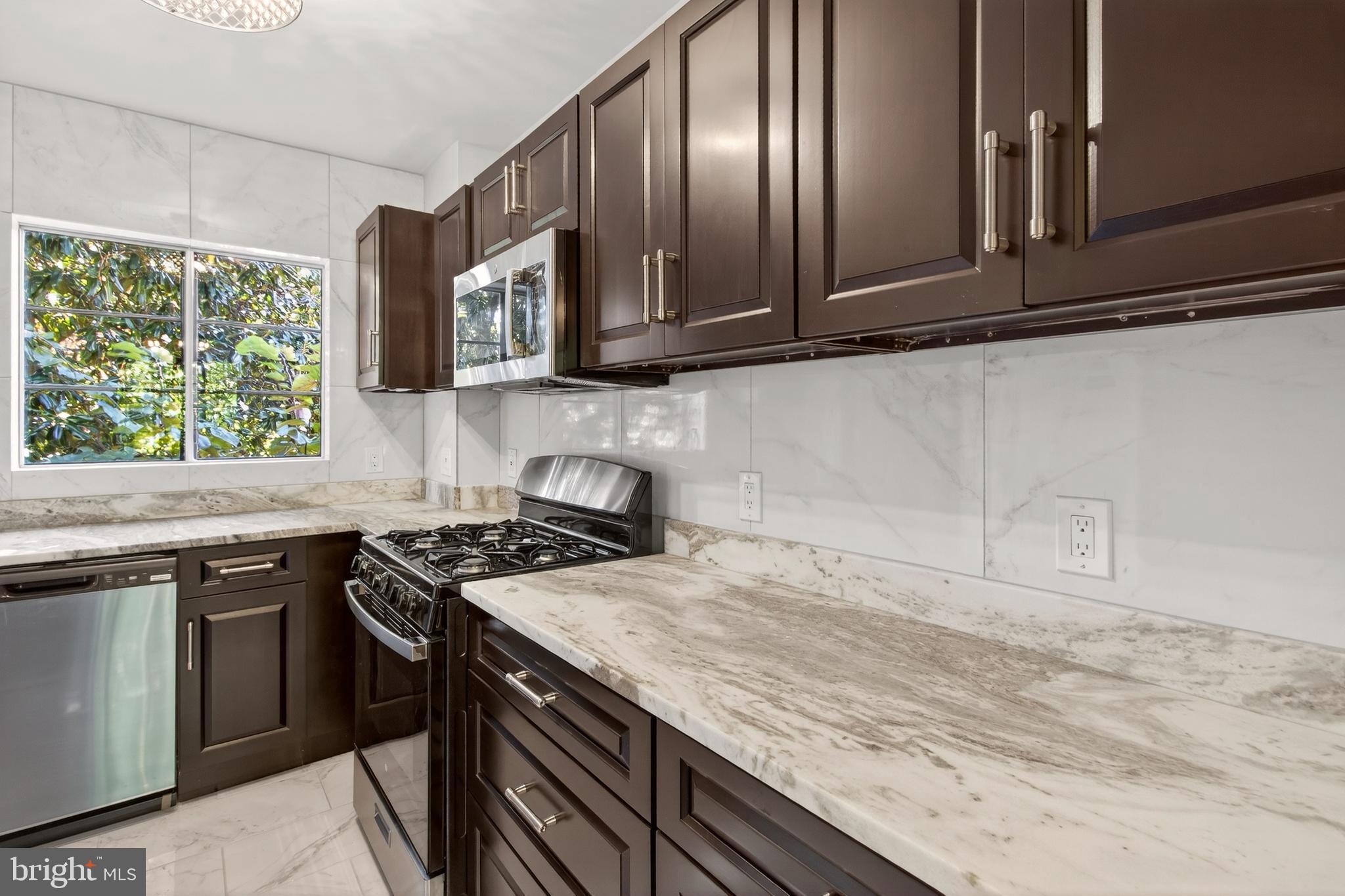 1649 Preston Road Alexandria, VA 22302 - Photo 11 of 31 a kitchen with granite countertop stainless steel appliances window a sink and cabinets