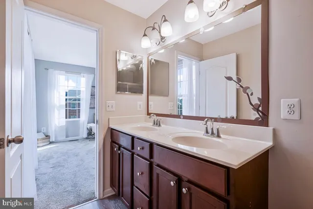 a bedroom with a bed wooden floor and window