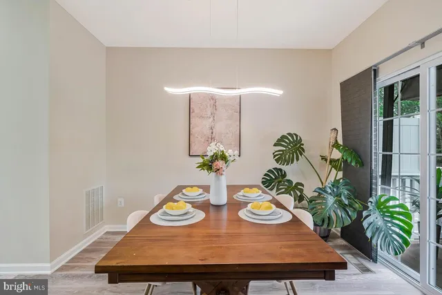 a wooden floor with table and chairs in it