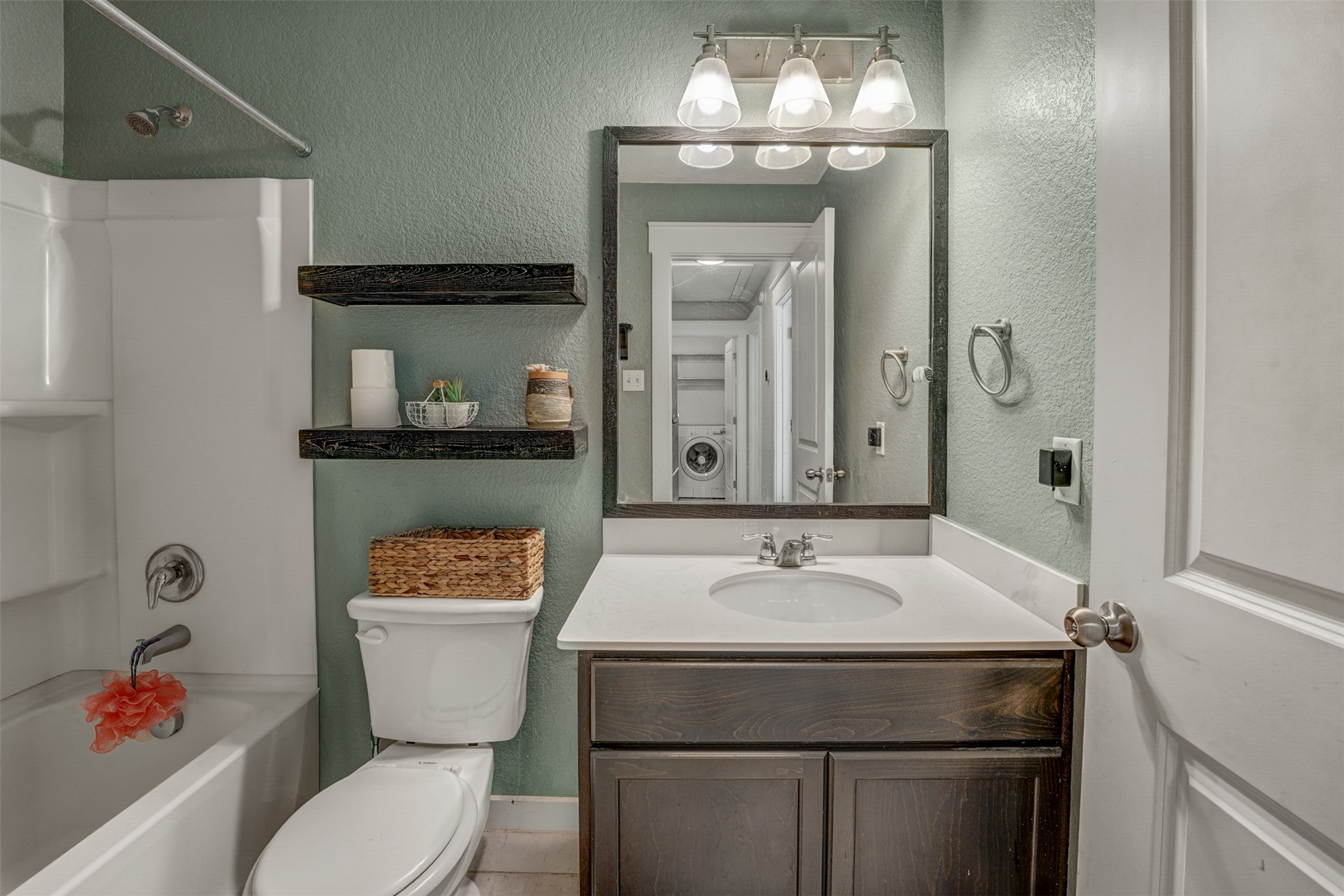 5806 Aviano Road Round Rock, TX 78665 - Photo 28 of 29 A pristine bath features floating shelves and a vanity with a bright, clean basin.