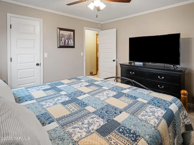 a bedroom with a bed and a flat screen tv