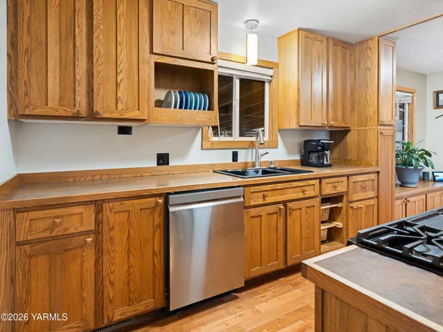 a kitchen with stainless steel appliances granite countertop a sink stove and cabinets