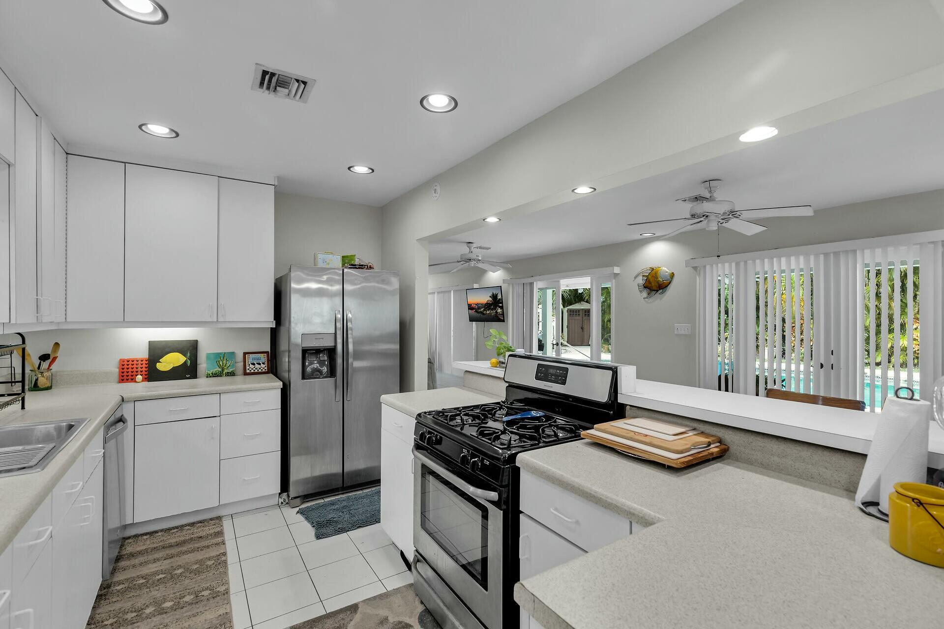 1106 17th Street Key West, FL 33040 - Photo 12 of 33 a kitchen with stainless steel appliances granite countertop a refrigerator and a stove top oven