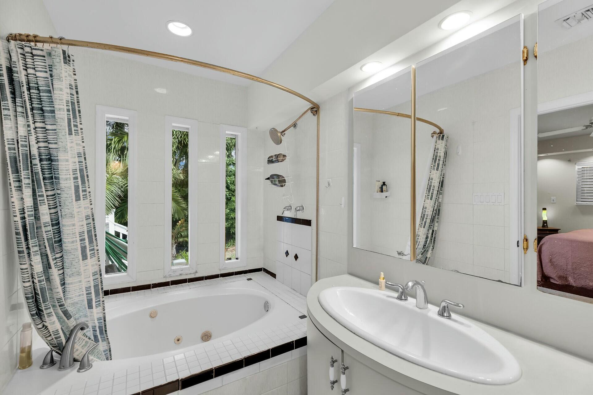 1106 17th Street Key West, FL 33040 - Photo 16 of 33 a bathroom with a tub sink and mirror