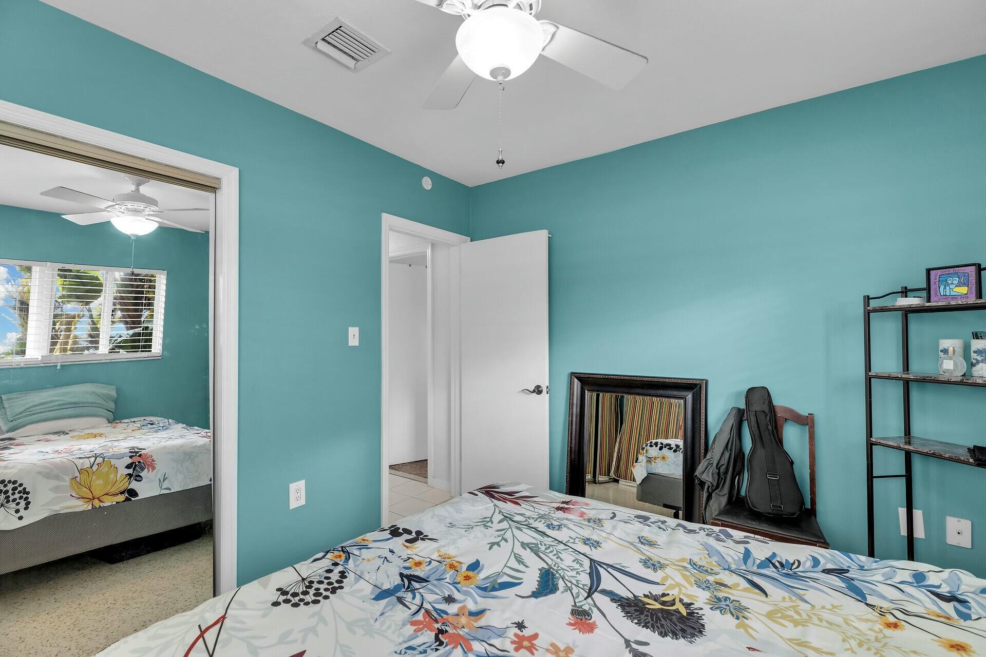 1106 17th Street Key West, FL 33040 - Photo 19 of 33 a bedroom with a bed and a chandelier
