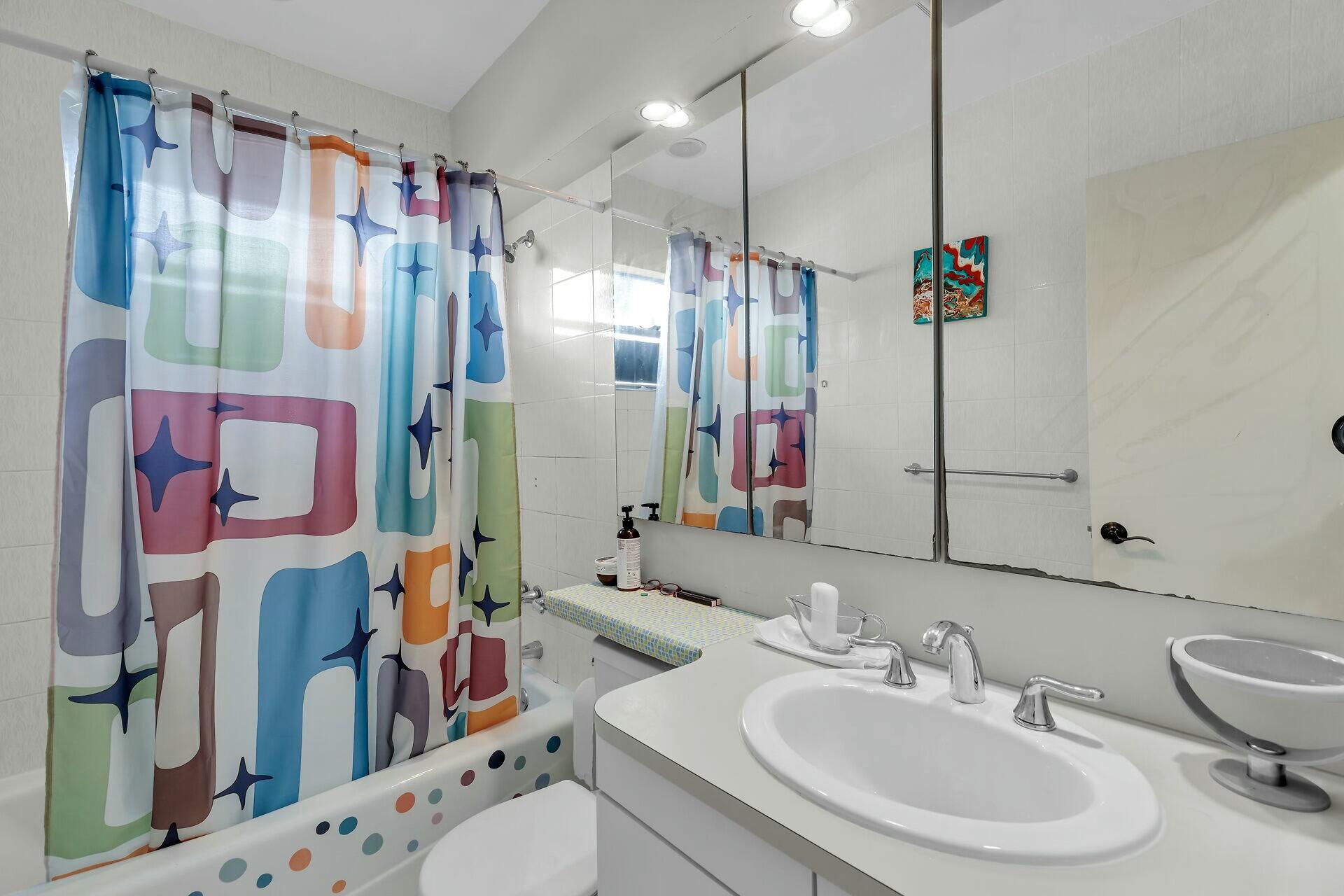 1106 17th Street Key West, FL 33040 - Photo 23 of 33 a bathroom with a sink vanity mirror and toilet