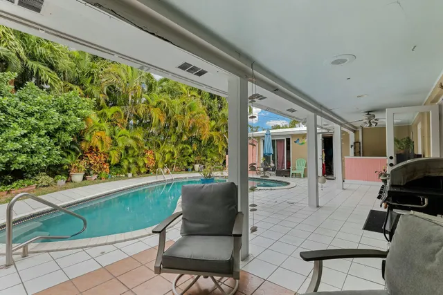 a view of a swimming pool with a outdoor seating