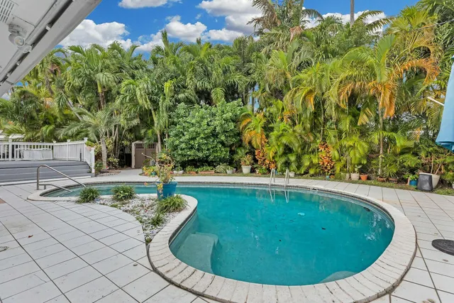 a view of a house with swimming pool and porch