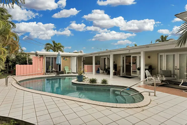 a view of a swimming pool with sitting area