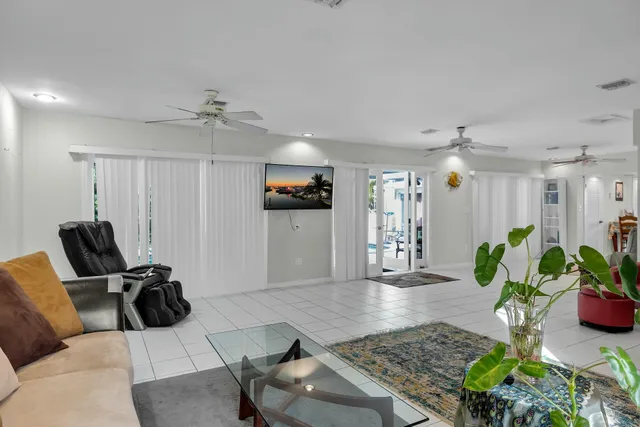 a living room with furniture gym equipment and a rug