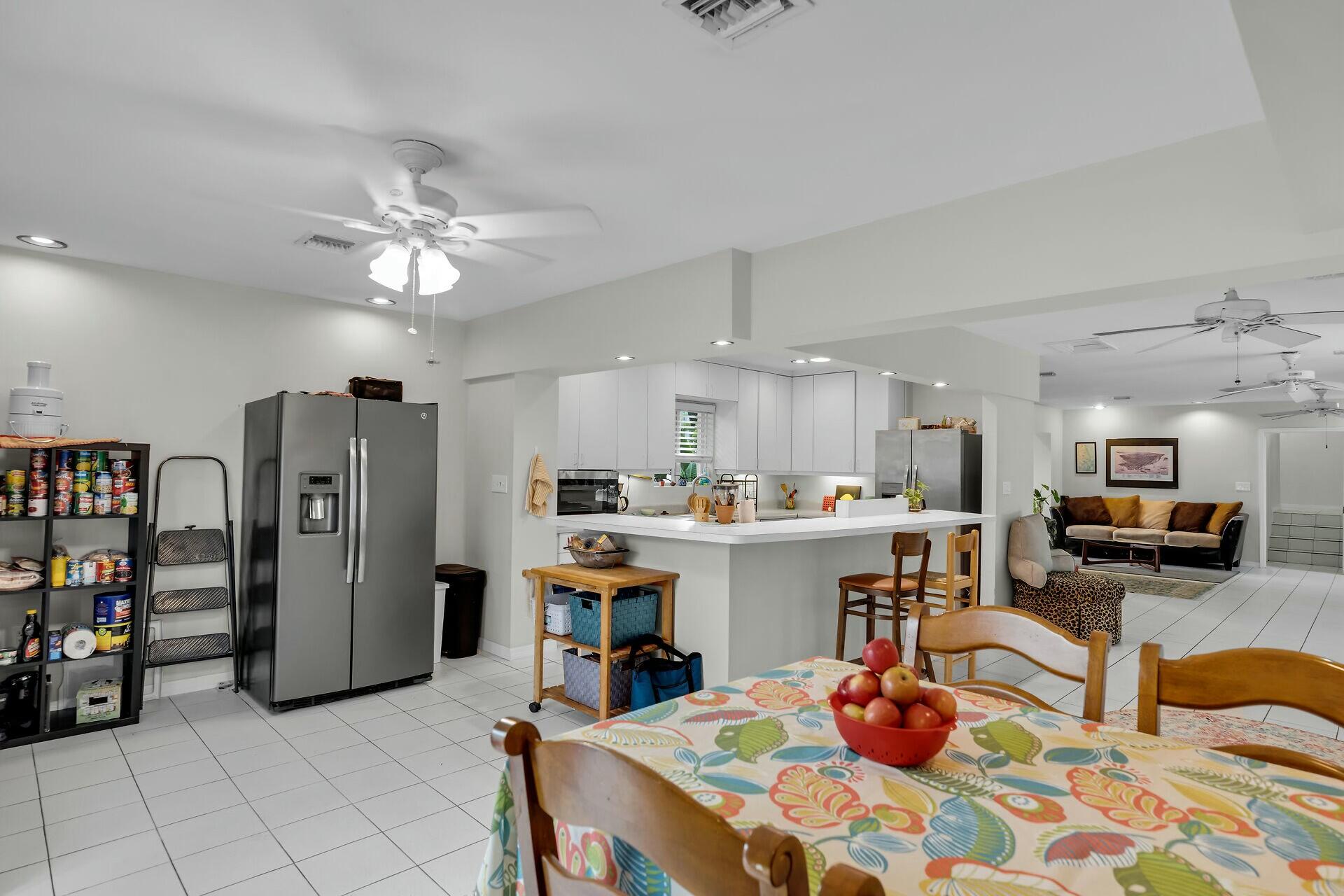 1106 17th Street Key West, FL 33040 - Photo 10 of 33 a kitchen with stainless steel appliances granite countertop a refrigerator and microwave