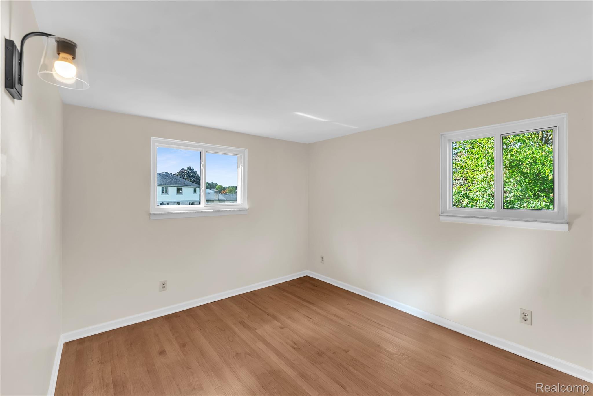 54011 Mound Road Utica, MI 48316 - Photo 15 of 27 Spare room featuring light wood-type flooring and baseboards