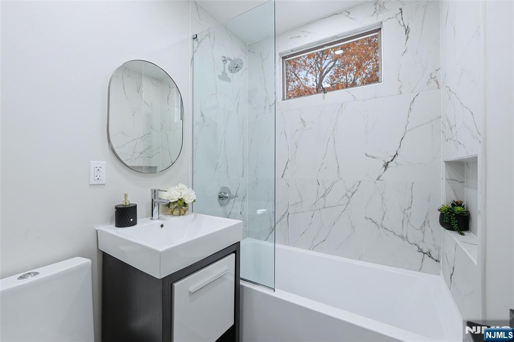 20 Dojean Court Bergenfield, NJ 07621 - Photo 12 of 30 a bathroom with a sink and a mirror