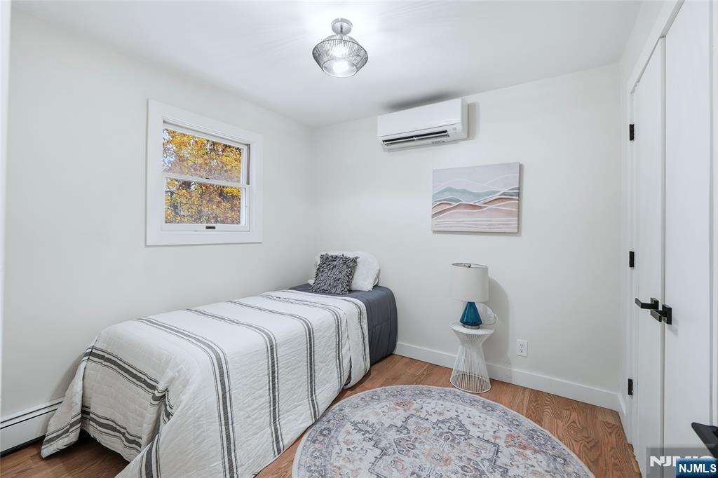 20 Dojean Court Bergenfield, NJ 07621 - Photo 13 of 30 a bedroom with a bed and a lamp