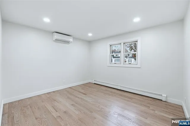 a view of a room with wooden floor and window