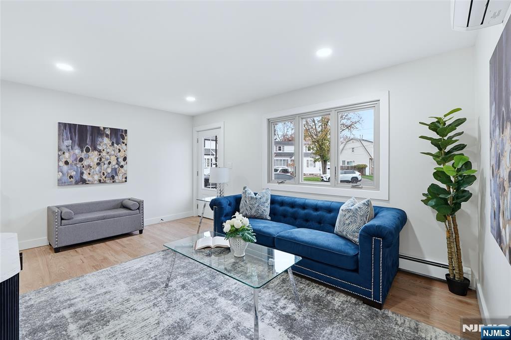 20 Dojean Court Bergenfield, NJ 07621 - Photo 5 of 30 a living room with furniture potted plant and a window