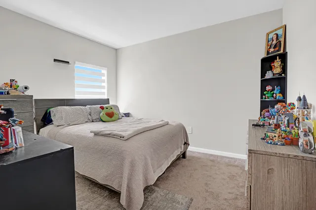 a bedroom with a bed and a bookshelf