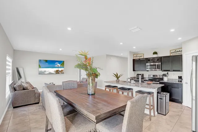 a dining room with furniture and a kitchen view