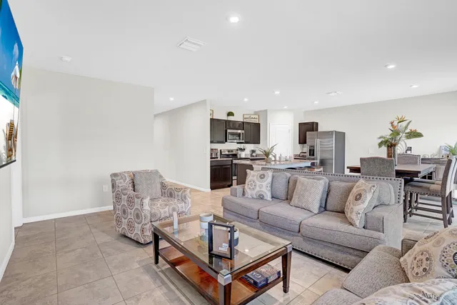 a living room with furniture and kitchen view