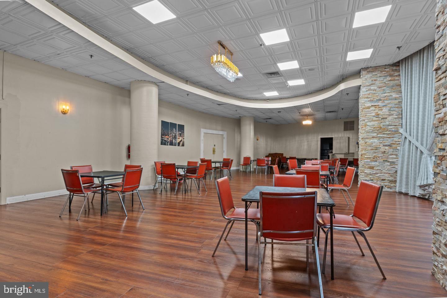 3900-00 West Ford Road, Unit 14K Philadelphia, PA 19131 - Photo 35 of 42 Spacious hall with modern decor and seating.