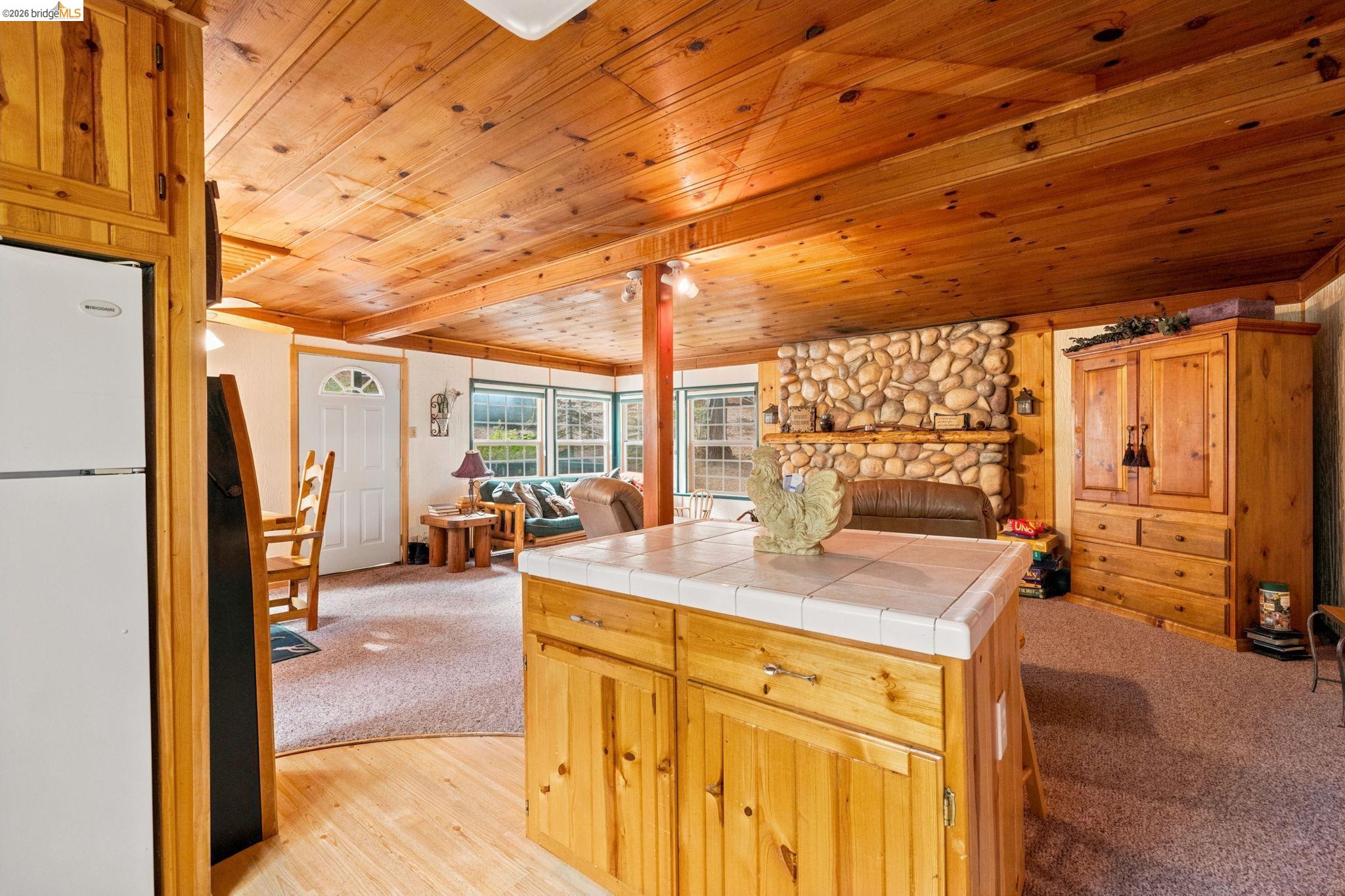 25822 Long Barn Sugar Pine Road Long Barn, CA 95335 - Photo 12 of 28 a view of a kitchen with a sink and a refrigerator