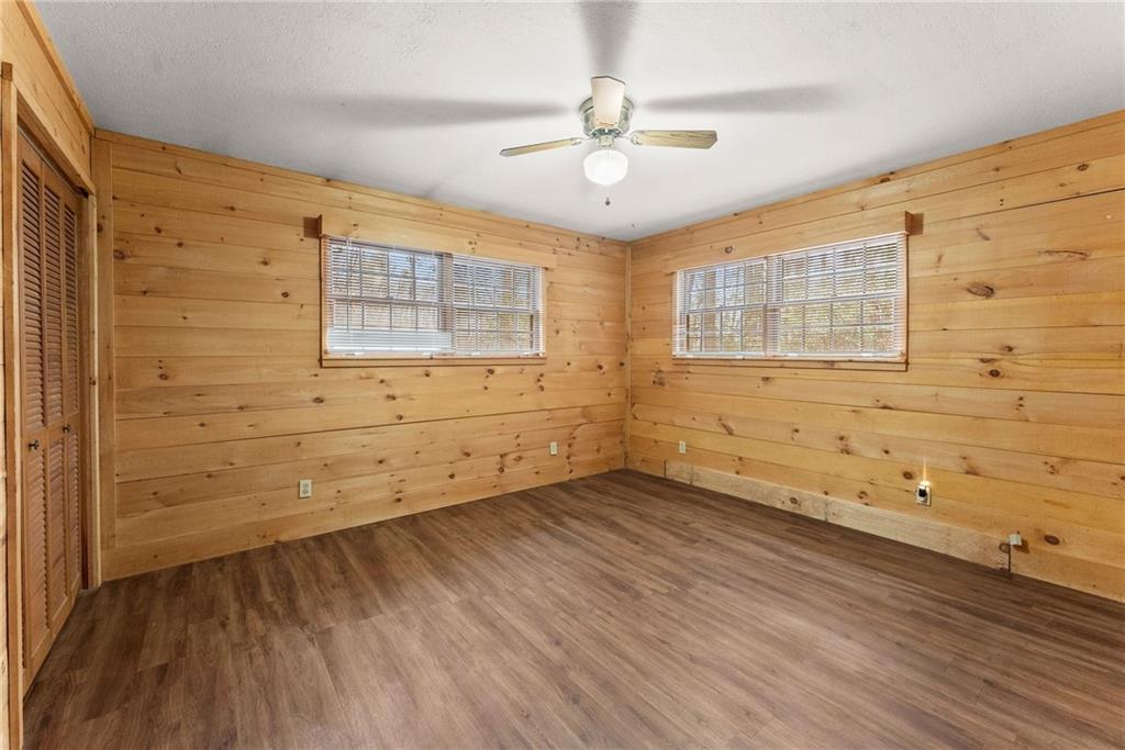 279 Cindy Cove Road Blairsville, GA 30512 - Photo 12 of 46 a view of an empty room with wooden floor and a window