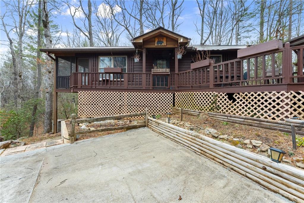 279 Cindy Cove Road Blairsville, GA 30512 - Photo 2 of 46 a front view of a house with a iron gate