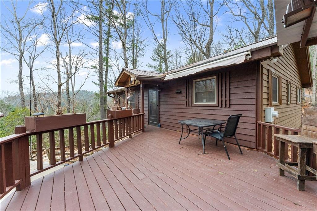 279 Cindy Cove Road Blairsville, GA 30512 - Photo 29 of 46 a backyard of a house with wooden floor outdoor seating and wooden fence
