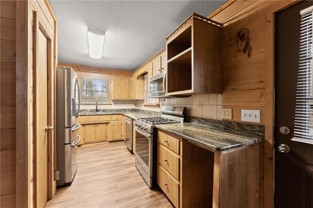 279 Cindy Cove Road Blairsville, GA 30512 - Photo 4 of 46 a kitchen with stainless steel appliances granite countertop a stove sink and cabinets