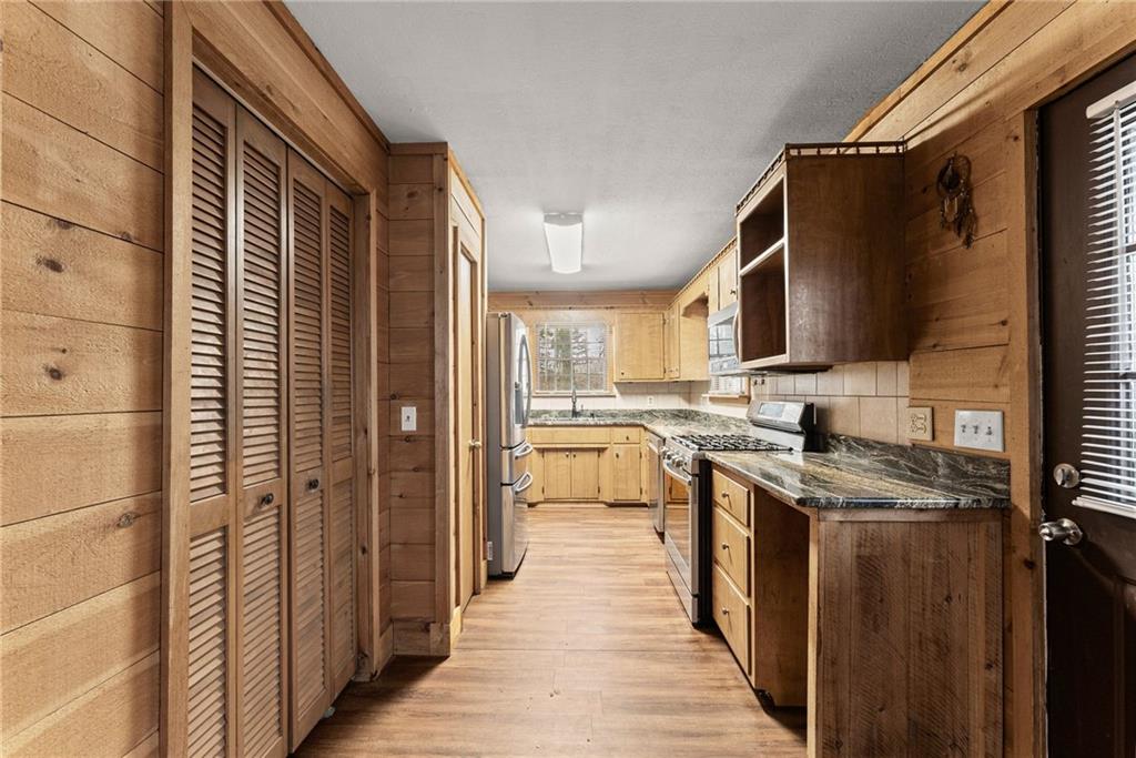 279 Cindy Cove Road Blairsville, GA 30512 - Photo 5 of 46 a kitchen with stainless steel appliances granite countertop a stove a sink and a refrigerator
