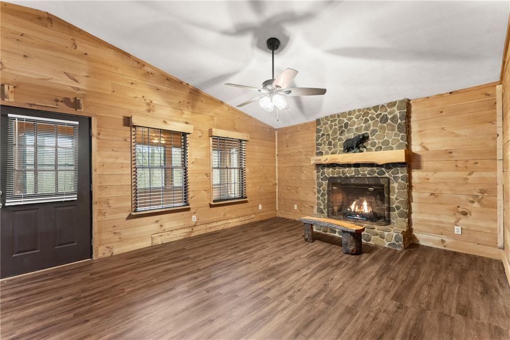 279 Cindy Cove Road Blairsville, GA 30512 - Photo 7 of 46 a view of an empty room with wooden floor and a fireplace