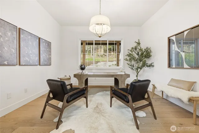 a view of a bedroom with furniture and mirror