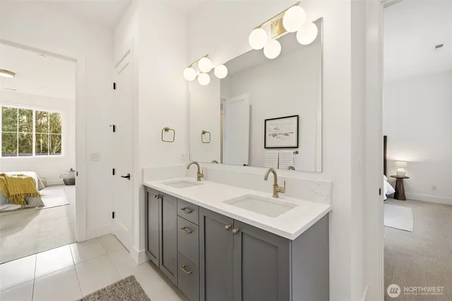 a bedroom with a bed a chair and next to a window